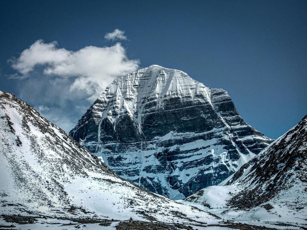 A breathtaking view of a majestic snow-capped mountain peak with a clear blue sky.